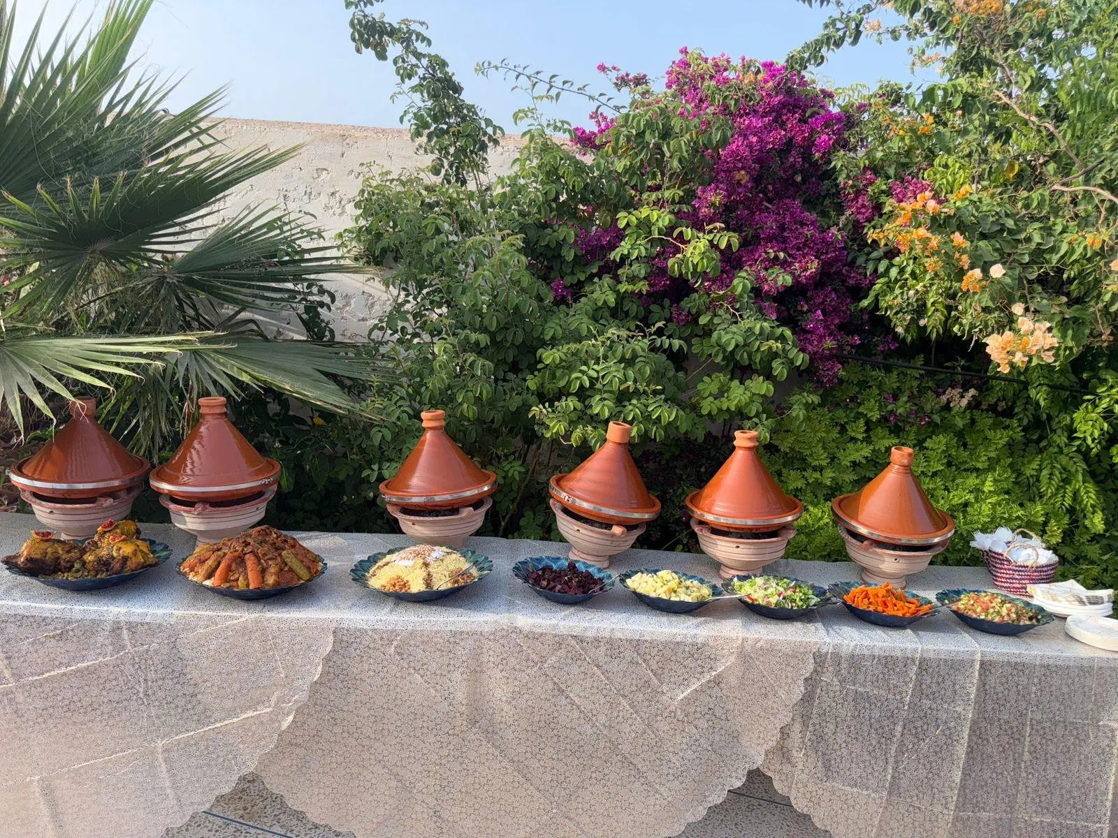 A table of Moroccan tagines in the Dar Cherfa garden