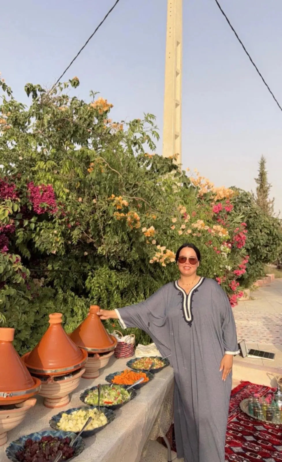 A Dar Cherfa host presenting a table of tagines