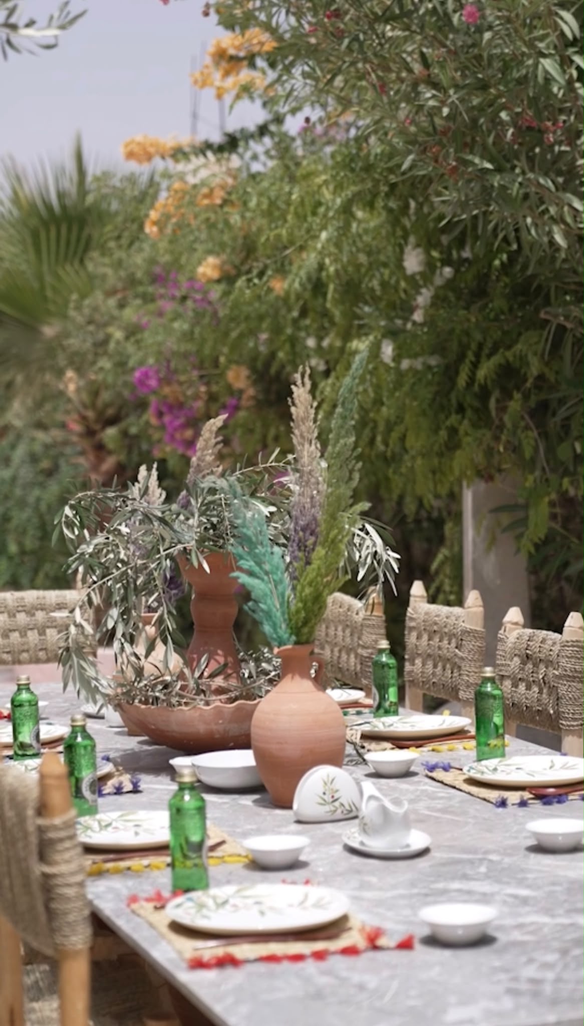 Terracotta vases and olive branches on the Dar Cherfa table