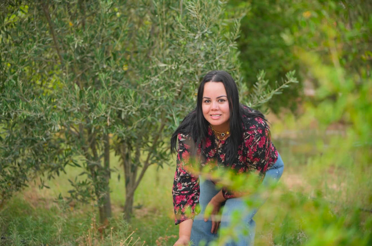 Lalla Meriam walking through the olive grove at Dar Cherfa